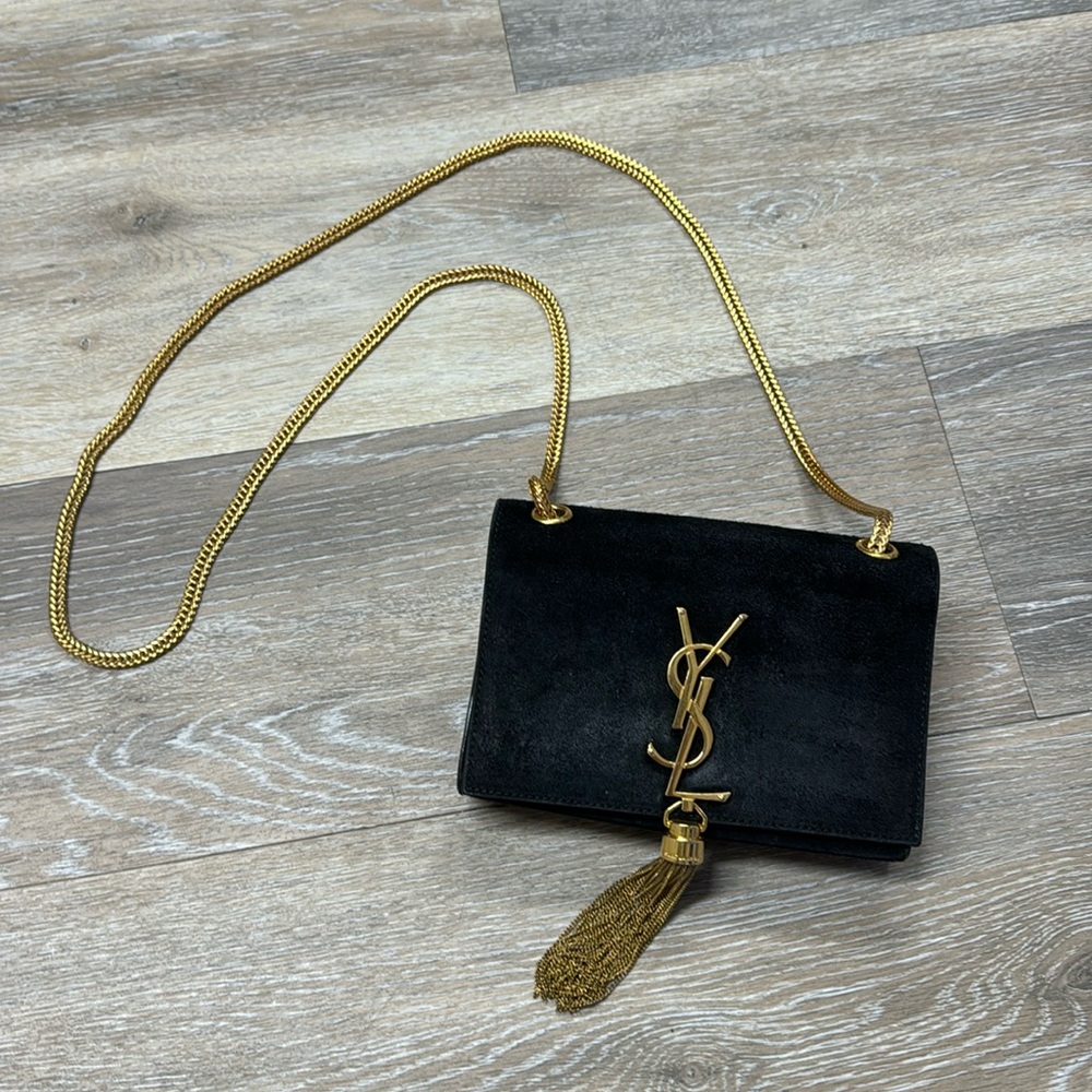 Authentic YSL bag in good condition black suede with gold tassel